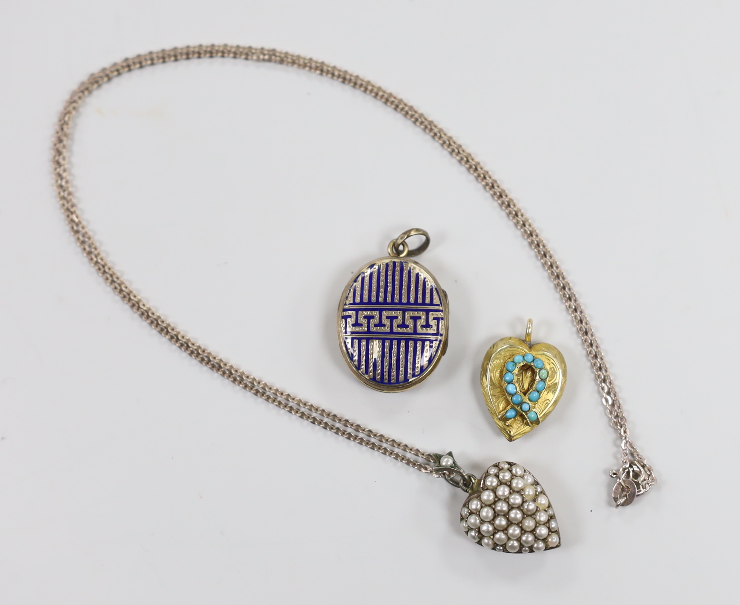 An early 20th century 9ct and seed pearl set heart shaped pendant, 16mm, on a later 925 chain, together with an enamelled locket and turquoise set heart shaped locket.